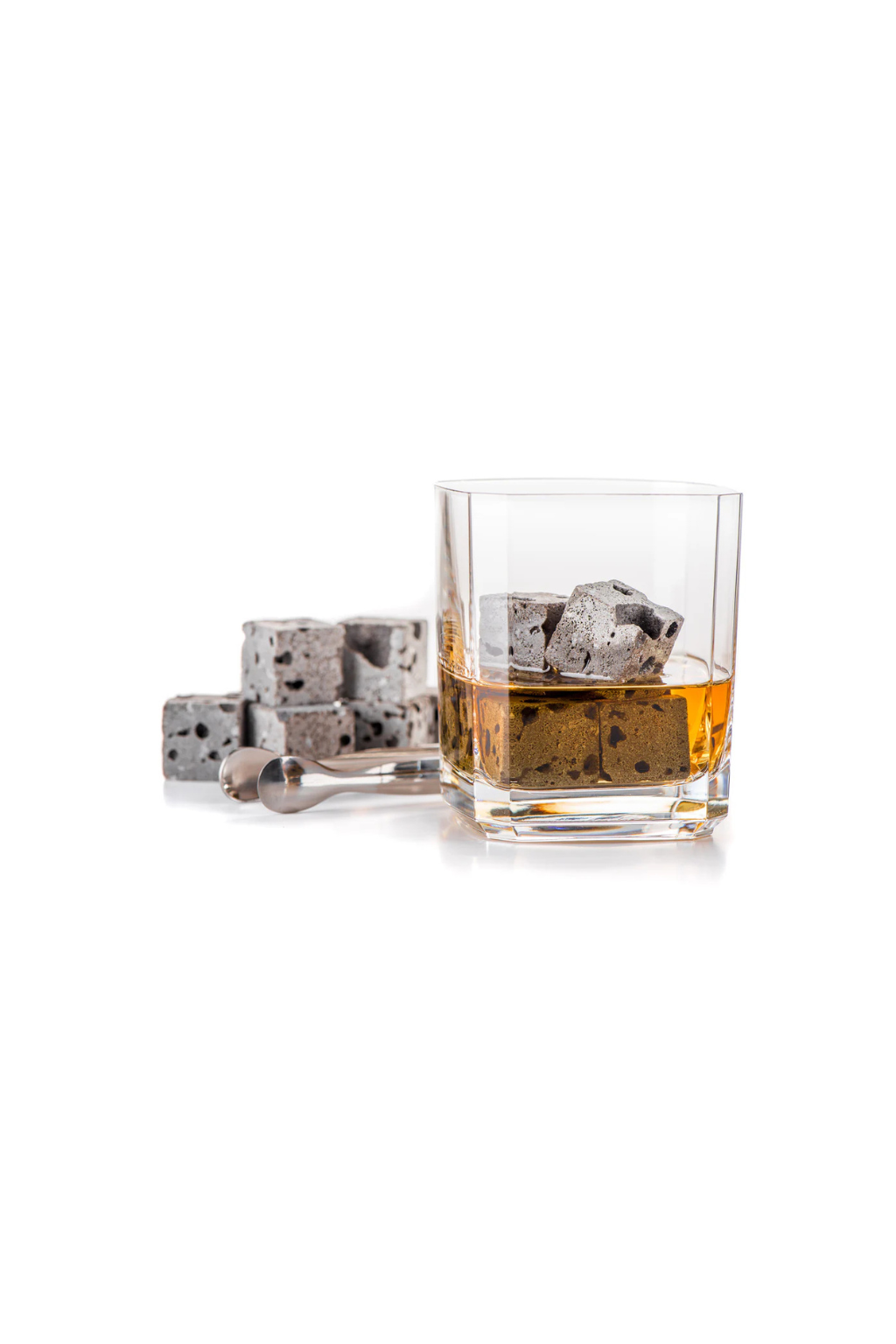 Glass of whiskey with lava Whiskey stones on a white background