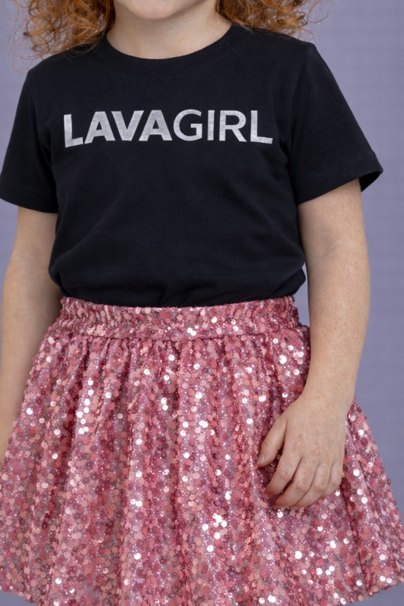 Child wearing a black t-shirt with 'LAVAGIRL' text and a pink sequin skirt.