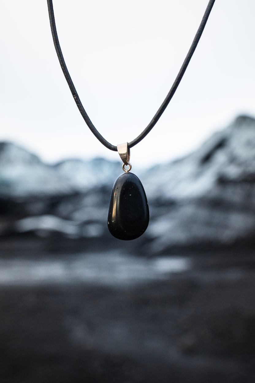 Lava Lava show necklace against a blurred natural background
