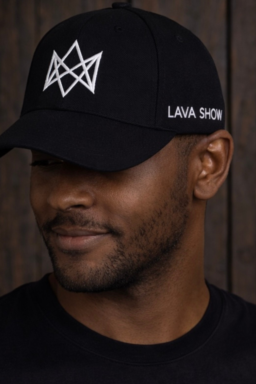 Man wearing a black cap with the Lava Show logo and 'LAVA SHOW' text against a wooden background
